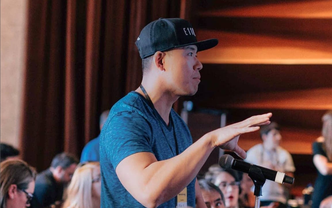 Mike Ke speaking at a dating confidence conference